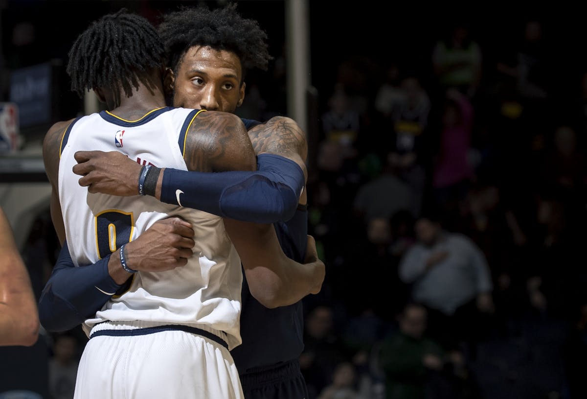 Jerami Grant (9) Denver Nuggets and Robert Covington (33) hugged at the end of the game.