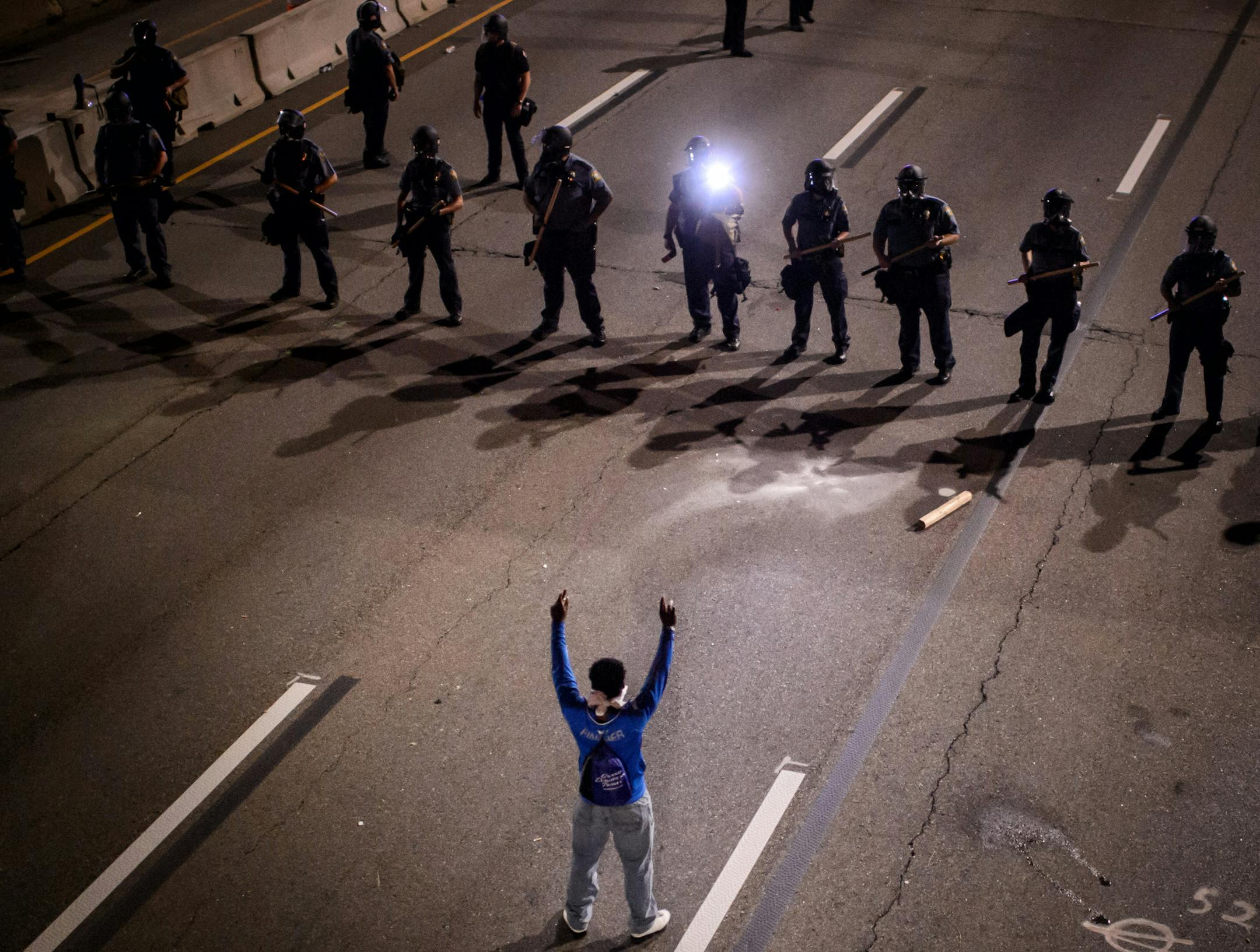 A lone protester waited to be arrested. ] GLEN STUBBE * gstubbe@startribune.com Friday, July 8, 2016 Black Lives Matter protest started in front of the Governor's Residence on Summit Avenue. From there protesters marched onto Lexington Ave and turned onto I-94 which they occupied for four hours. ORG XMIT: MIN1607100425263119