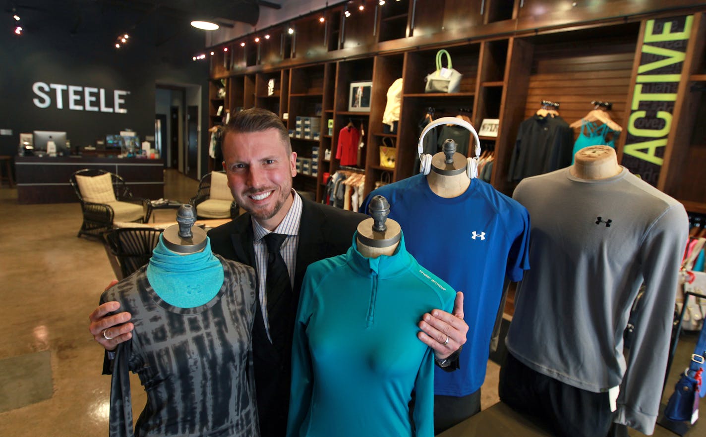 Steele Smiley, CEO of Steele Smiley, with some of his co-branded merchandise from Under Armor at the location in Edina. [ STAR TRIBUNE/TOM WALLACE Assignments #20028729A Apri 25, 2013 EXTRA INFORMATION SLUG: 591396 STEELE043013 EXTRA INFORMATION: Steele Fitness, based in Golden Valley, will open an Under Armor store within a store concept in May at its location in Edina.