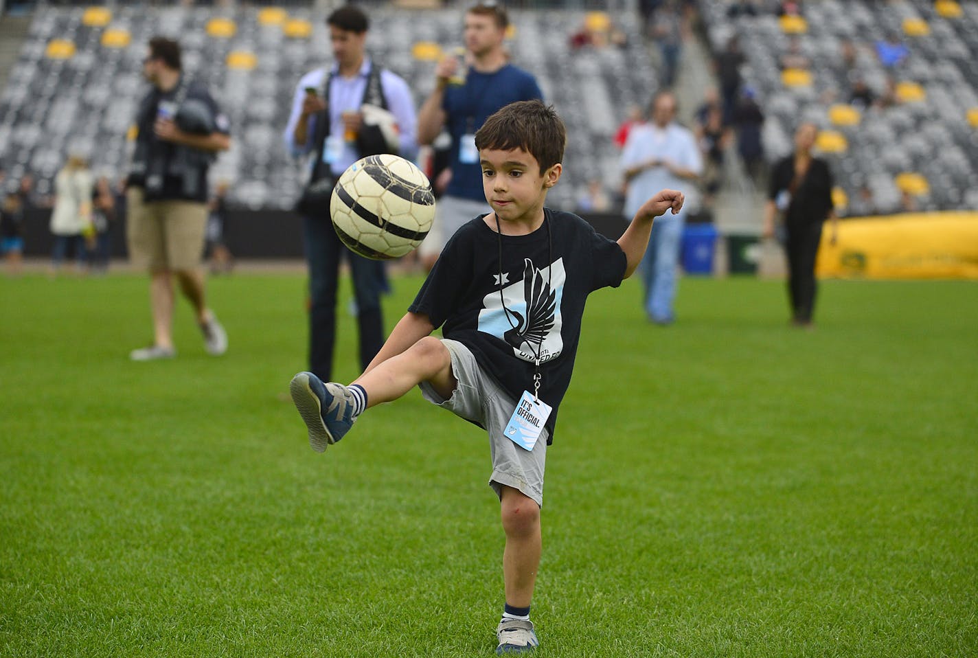 Kian Fitchett, 6, of Minneapolis, kicked around a soccer ball with his father Christian, an Minnesota United FC season ticket holder, before Friday evening's announcement. ] (AARON LAVINSKY/STAR TRIBUNE) aaron.lavinsky@startribune.com Major League Soccer Commissioner Don Garber, Minnesota United majority owner Dr. William McGuire, Minnesota Governor Mark Dayton and St. Paul Mayor Chris Coleman took part in an event announcing Minnesota United FC's move to the MLS Friday, August 19, 2016 at CHS F