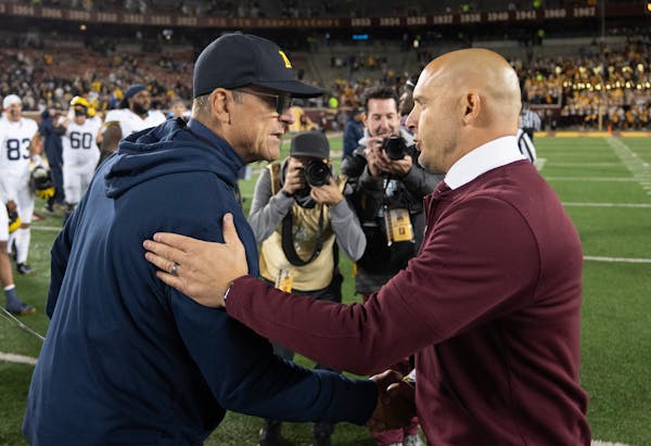 Michigan coach Jim Harbaugh, left, shook hands with Gophers coach P.J. Fleck after the Wolverines defeated Minnesota 52-10 on Oct. 7 at Huntington Ban