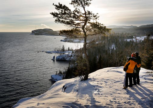 At one of the most breathtaking vistas along the North Shore, two hikers enjoy the view from Shovel Point in Tettegouche State Park.