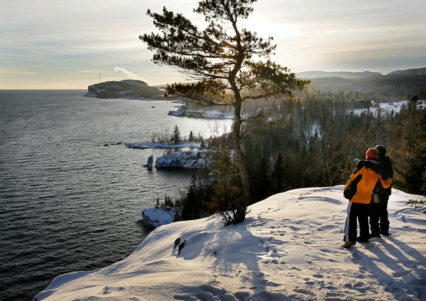 At one of the most breathtaking vistas along the North Shore, two hikers enjoy the view from Shovel Point in Tettegouche State Park.