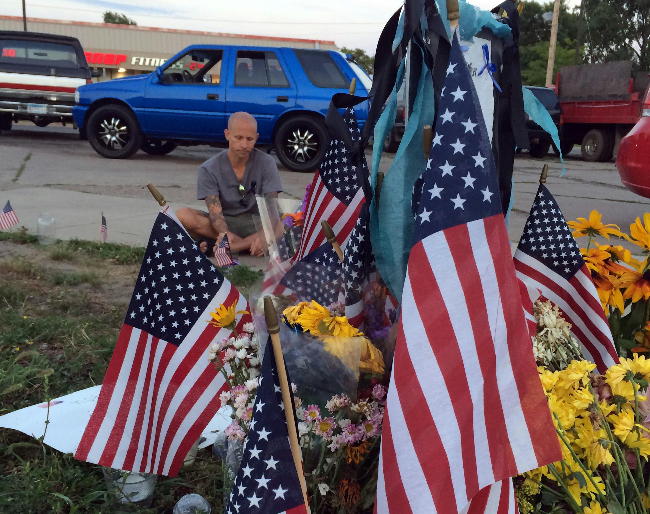 Jason Serbesku spends time at the memorial to Scott Patrick, re-lighting candles, removing flowers and keeping it clean.
