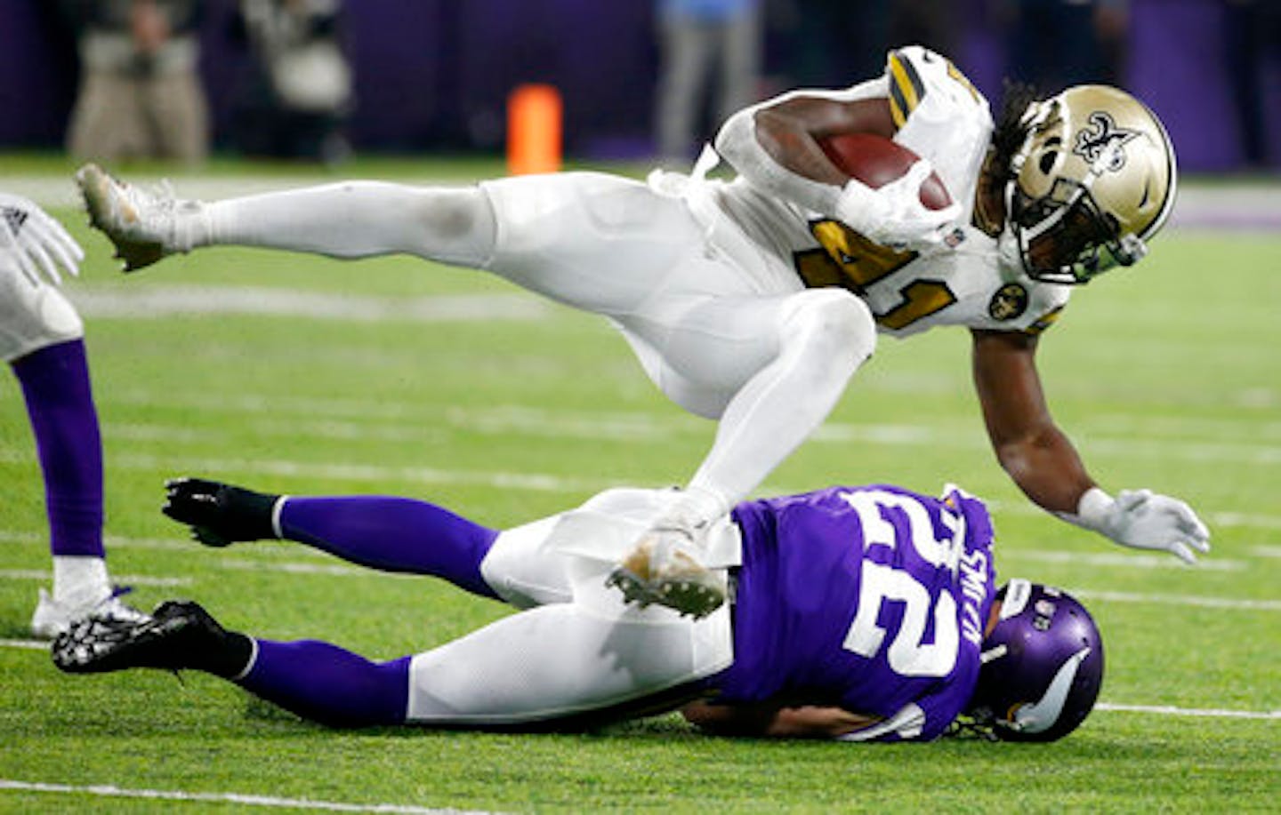 New Orleans Saints running back Alvin Kamara (41) dives over Minnesota Vikings free safety Harrison Smith (22) during the first half of an NFL football game, Sunday, Oct. 28, 2018, in Minneapolis. (AP Photo/Bruce Kluckhohn)