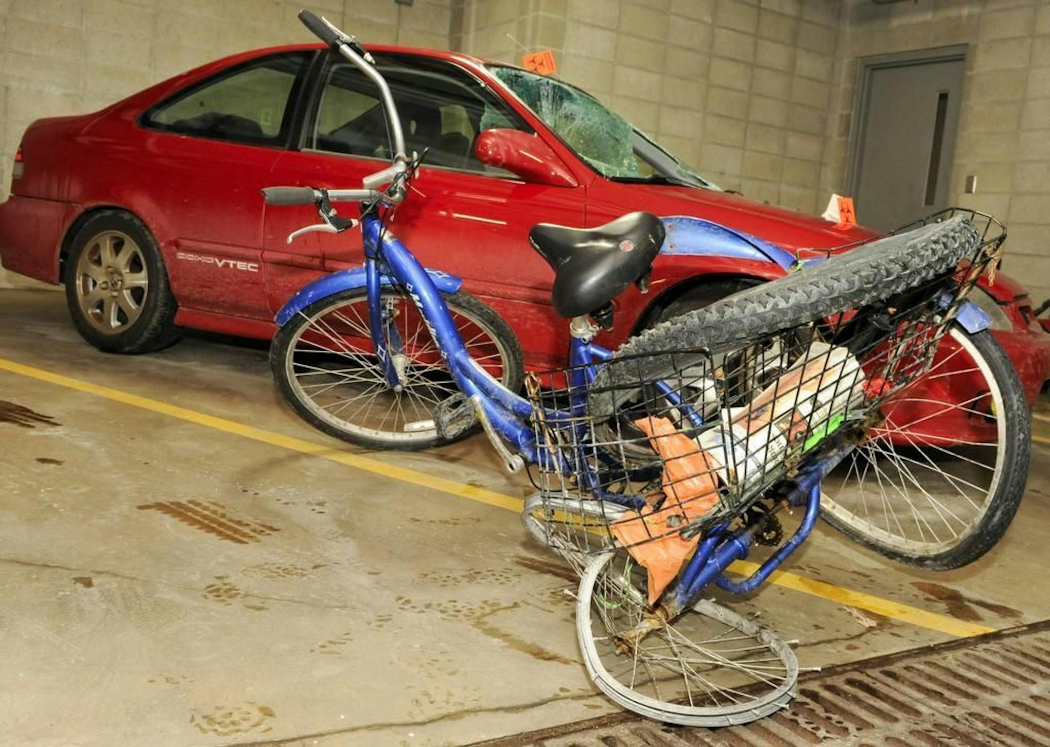 This Jan. 21, 2014 photo shows Steven Gove's three-wheeled tricycle and the car that hit him Saturday night.