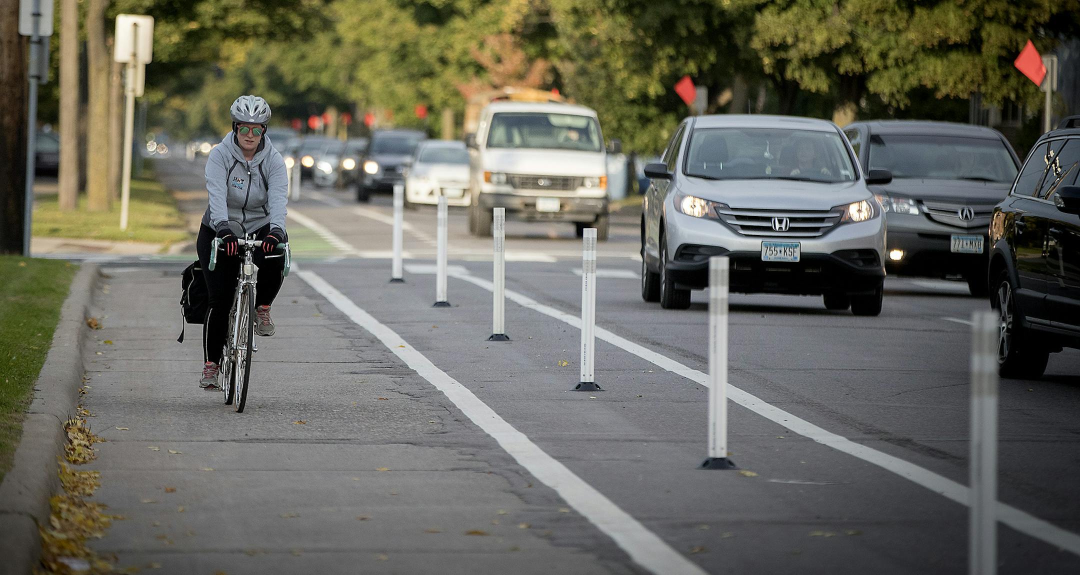 A bicyclist made her way down the bike lane during rush hour near Blaisdell Avenue and 26th Street, Friday, October 13, 2017 in Minneapolis, MN. New bike lanes are cropping up around the Twin Cities, creating a divide between cyclists who feel safer riding in a lane and motorists, residents and business owners frustrated by lost space for driving and parking. Many of the lanes have been added within the last five years, as a result of comprehensive bicycle master plans in both Minneapolis and St