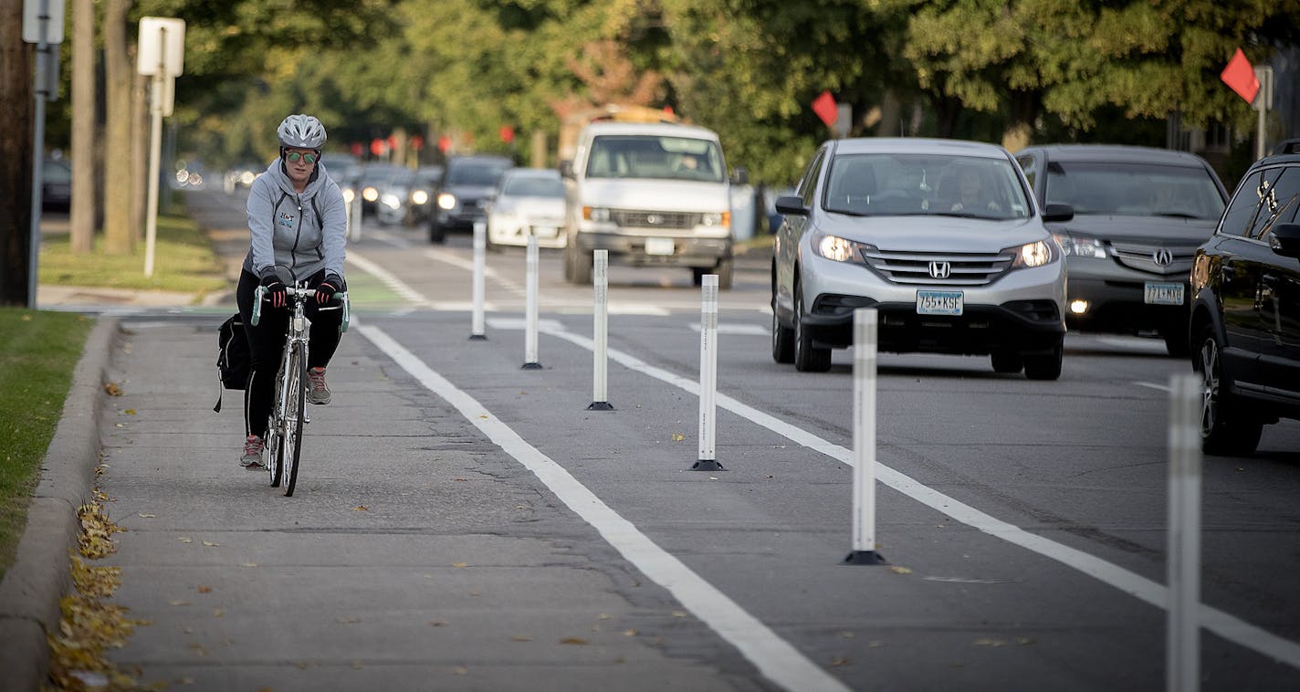 A bicyclist made her way down the bike lane during rush hour near Blaisdell Avenue and 26th Street, Friday, October 13, 2017 in Minneapolis, MN. New bike lanes are cropping up around the Twin Cities, creating a divide between cyclists who feel safer riding in a lane and motorists, residents and business owners frustrated by lost space for driving and parking. Many of the lanes have been added within the last five years, as a result of comprehensive bicycle master plans in both Minneapolis and St