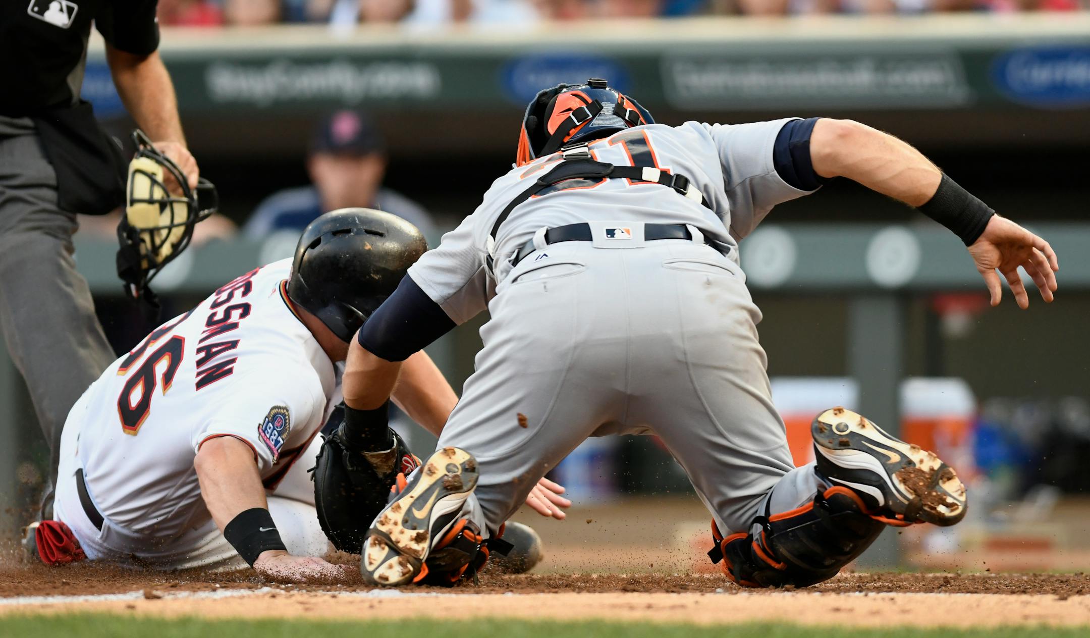 Detroit Tigers catcher Alex Avila, right, tags out Minnesota Twins' Robbie Grossman attempting to score on a single by Zack Granite during the third inning of a baseball game Saturday, July 22, 2017, in Minneapolis. (AP Photo/Tom Olmscheid)