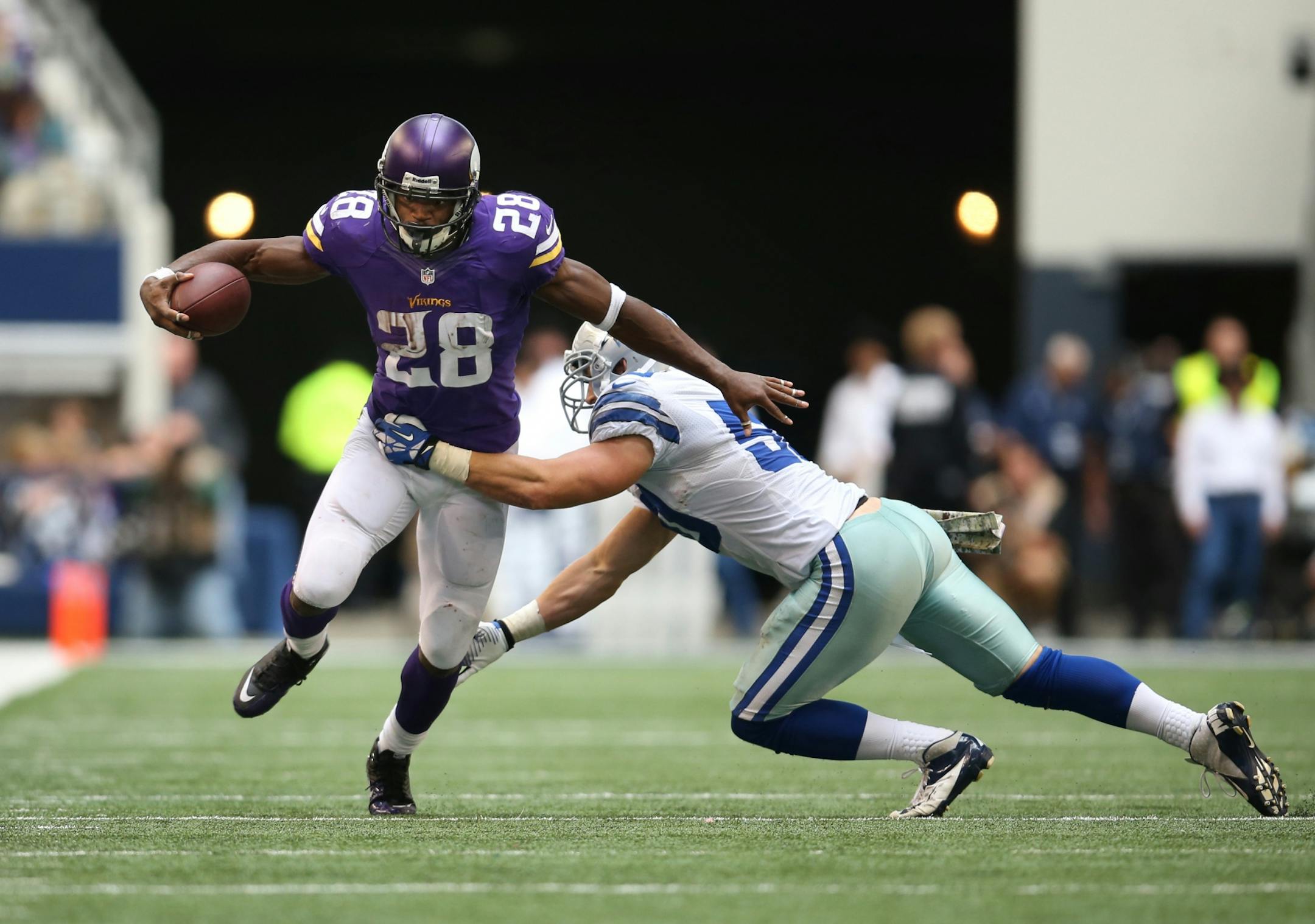 Vikings running back Adrian Peterson broke a tackle by linebacker Sean Lee on a 12-yard pass play in the third quarter.