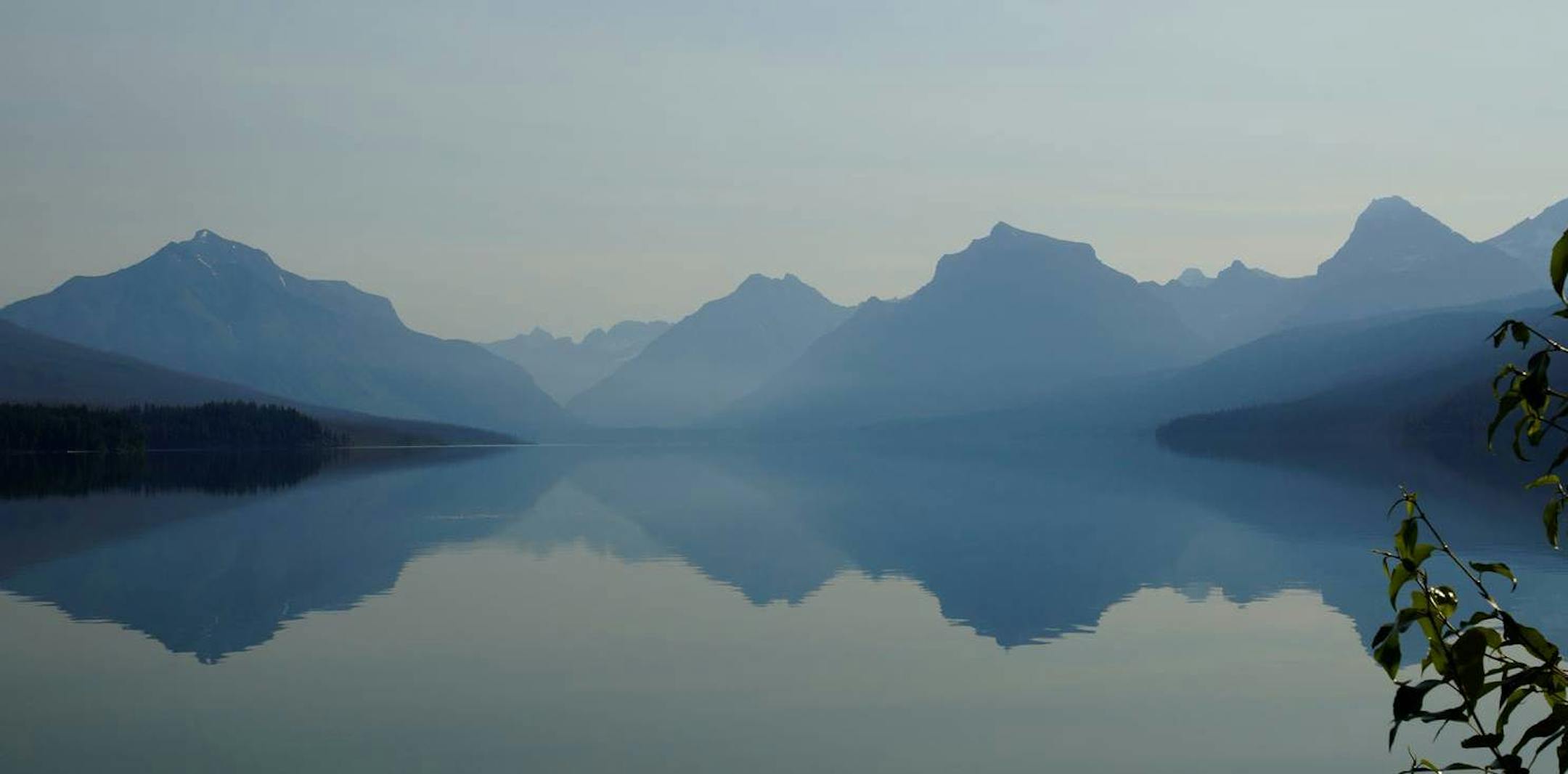 Lake McDonald mirrored mountains peaks in Glacier National Park.
