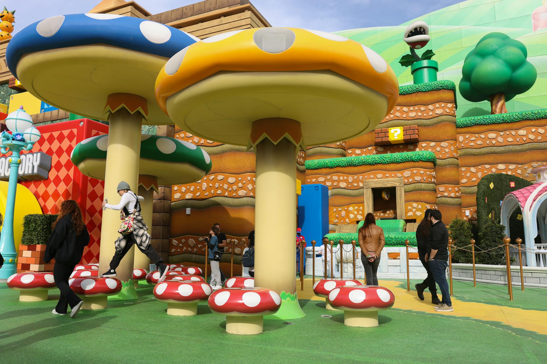 People play on top of the large mushrooms for the tech rehearsals at Super Nintendo World on Thursday, Jan. 12, 2023, in Los Angeles. (Dania Maxwell/Los Angeles Times/TNS) ORG XMIT: 69177597W