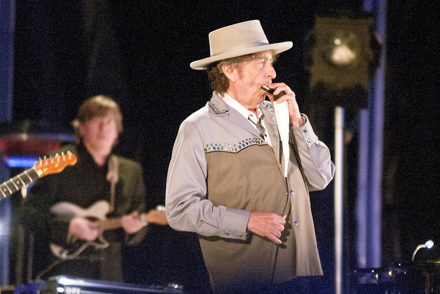 Bob Dylan plays harmonica with his Band while performing at Bayfront Festival Park in Duluth, Minn. Tuesday July 9, 2013 during a stop on the Americanarama Festival of Music. (AP Photo/Duluth News, Clint Austin) ORG XMIT: MIN2013071009440014