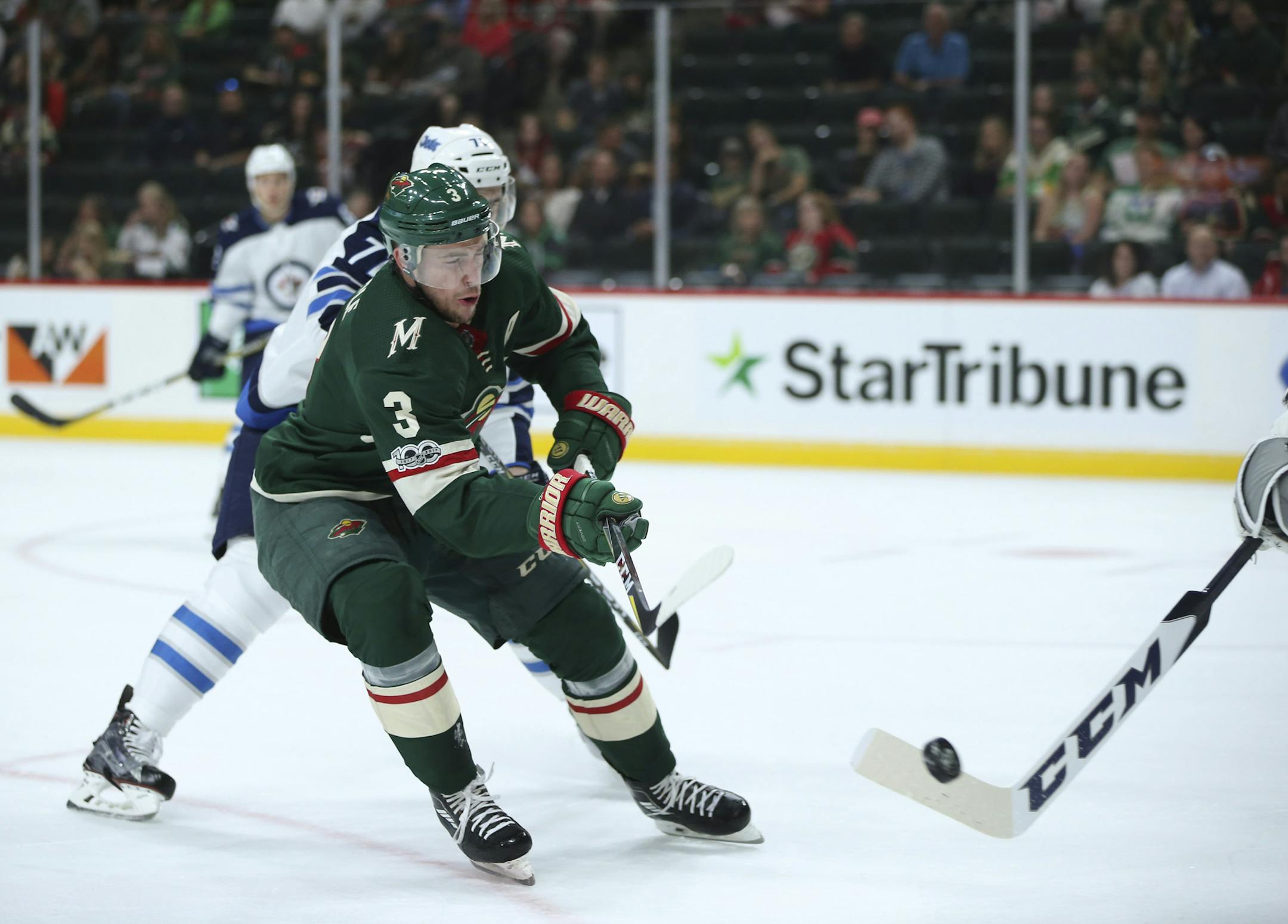 The Minnesota Wild's Charlie Coyle (3) tries to knock down the puck being cleared by Winnipeg Jets goalie Connor Hellebuyck in the first period, while defended by the Winniped Jets' Julian Melchiori in a preseason game on Thursday, Sept. 21, 2017, at Xcel Energy Center in St. Paul, Minn. (Jeff Wheeler/Minneapolis Star Tribune/TNS) ORG XMIT: 1213278