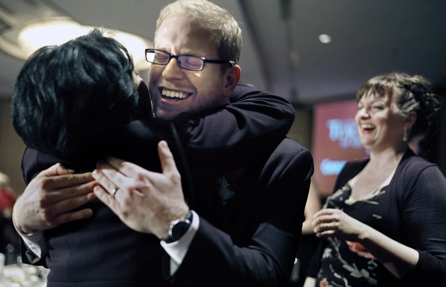 Thomas Rademacher, an English teacher at the FAIR School in the West Metro Education Program, celebrated his MInnesota Teacher of the year award with a hug from past 2006 winner Lee-Ann Stephens of St. Louis Park. His wife Laura is in the background. ]richard.tsong-taatarii/rtsong-taatarii@startribune.com