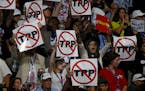 California delegates hold up signs against the Trans-Pacific Partnership on the first night of the Democratic National Convention on Monday, July 25, 