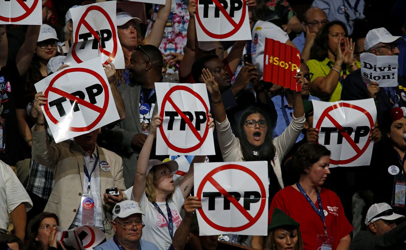 California delegates hold up signs against the Trans-Pacific Partnership on the first night of the Democratic National Convention on Monday, July 25, 2016 in Philadelphia, Pa. (Carolyn Cole/Los Angeles Times/TNS) ORG XMIT: 1187676 ORG XMIT: MIN1607251738160531