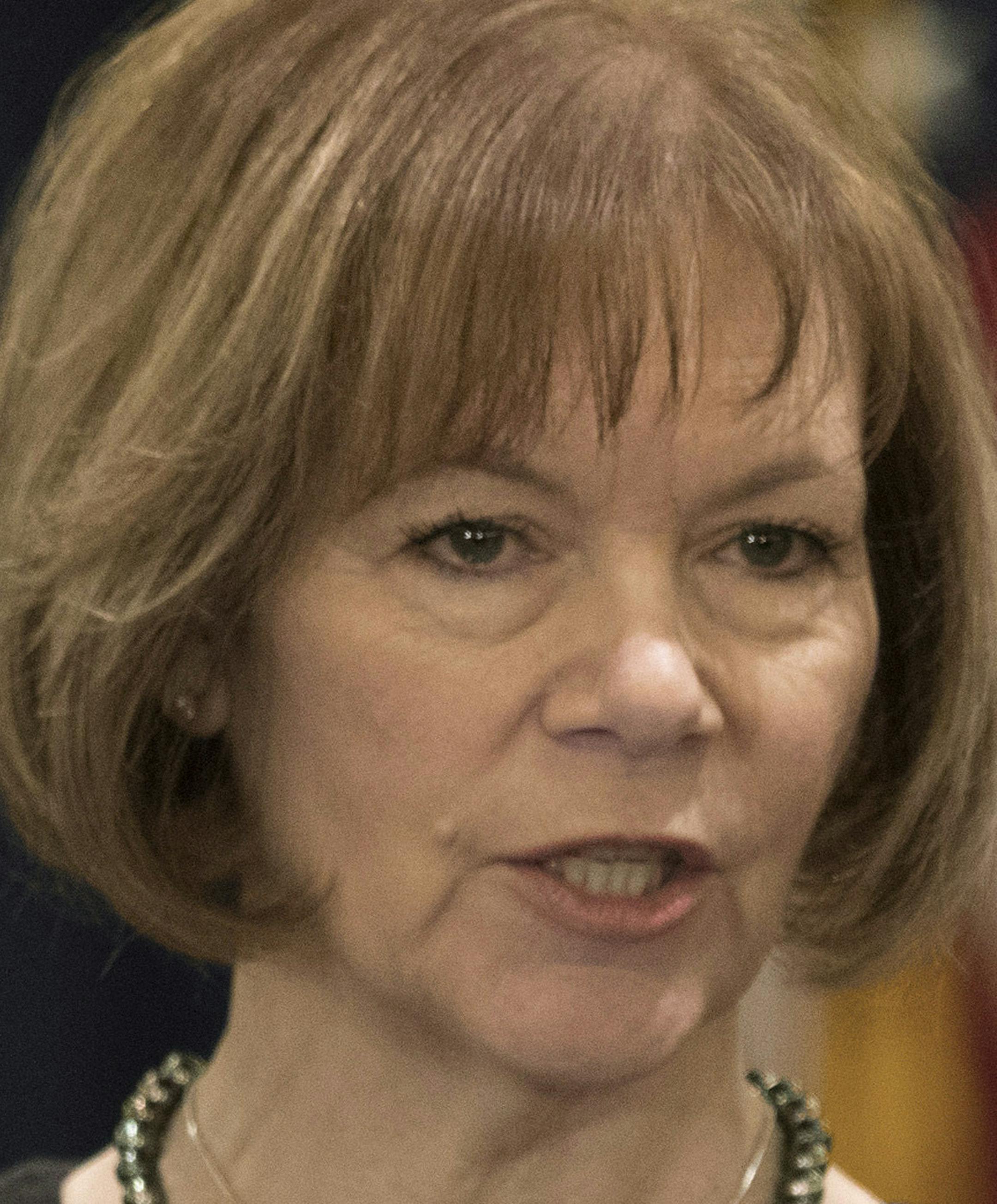 Minnesota Gov. Mark Dayton listens to Lt. Gov. Tina Smith during a news conference, as she was named to replace fellow Democrat Al Franken in the U.S. Senate on Wednesday, Dec. 13, 2017 in St. Paul, Minn. Franken announced his resignation last week amid growing sexual misconduct allegations. (Brian Peterson/Star Tribune via AP)