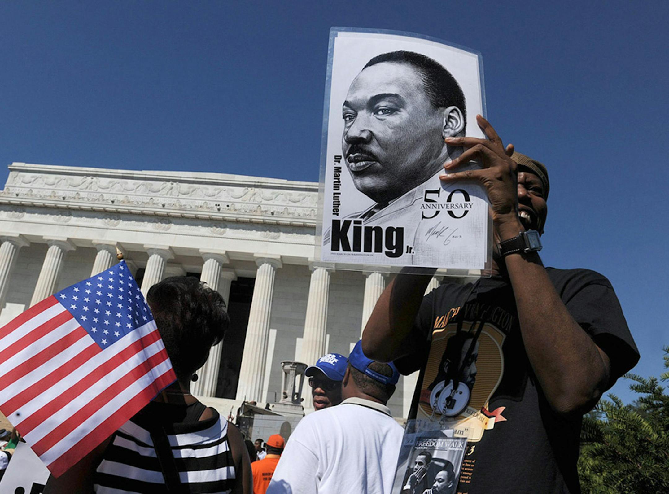 People listen to speakers during the 50th anniversary of the March on Washington and Dr. Martin Luther King Jr.'s "I have a Dream" speech at the Lincoln Memorial in Washington, D.C., Saturday, August 24, 2013.