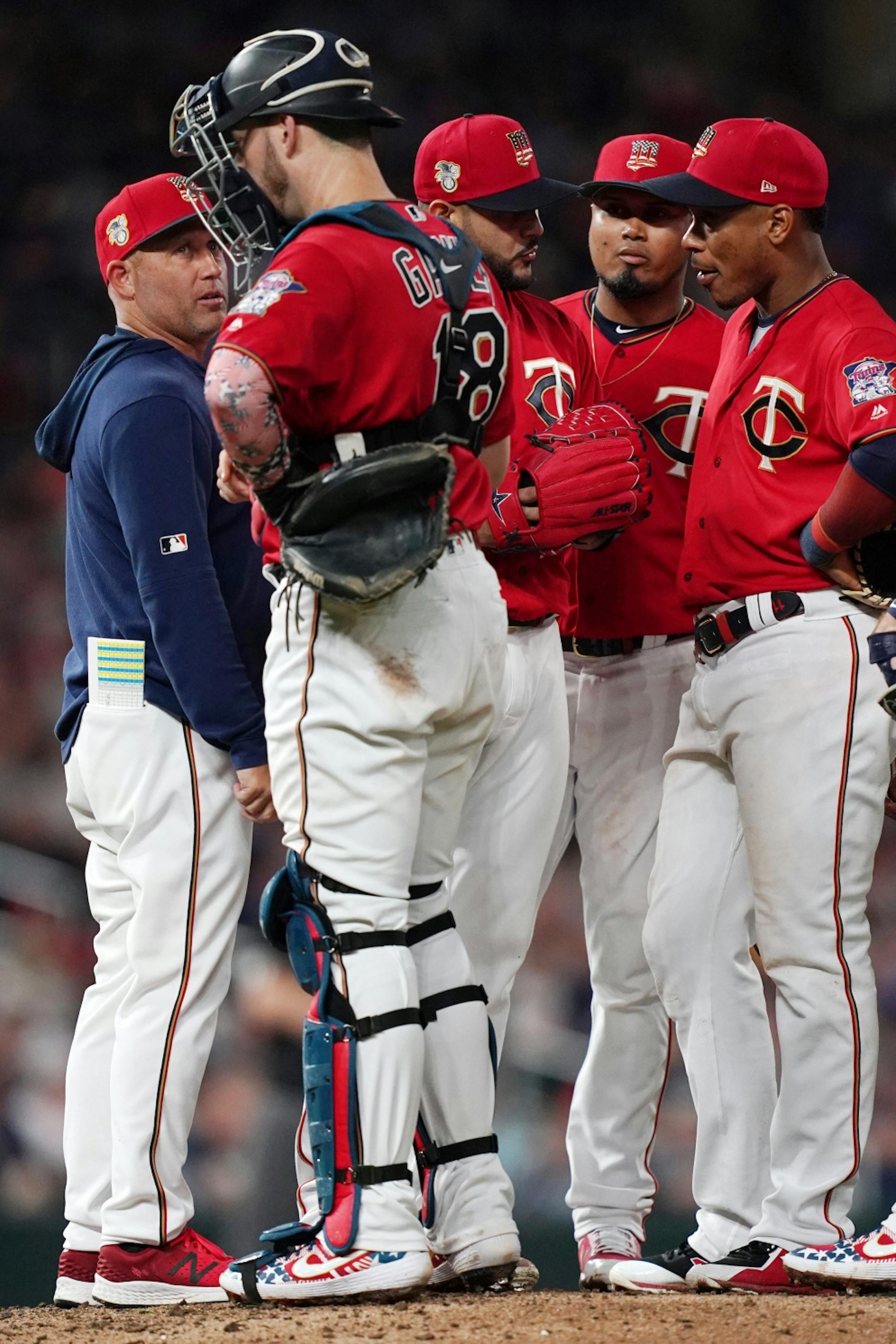Minnesota Twins pitching coach Wes Johnson (47) talked with Minnesota Twins catcher Mitch Garver (18) as he visited the mound in the seventh inning.