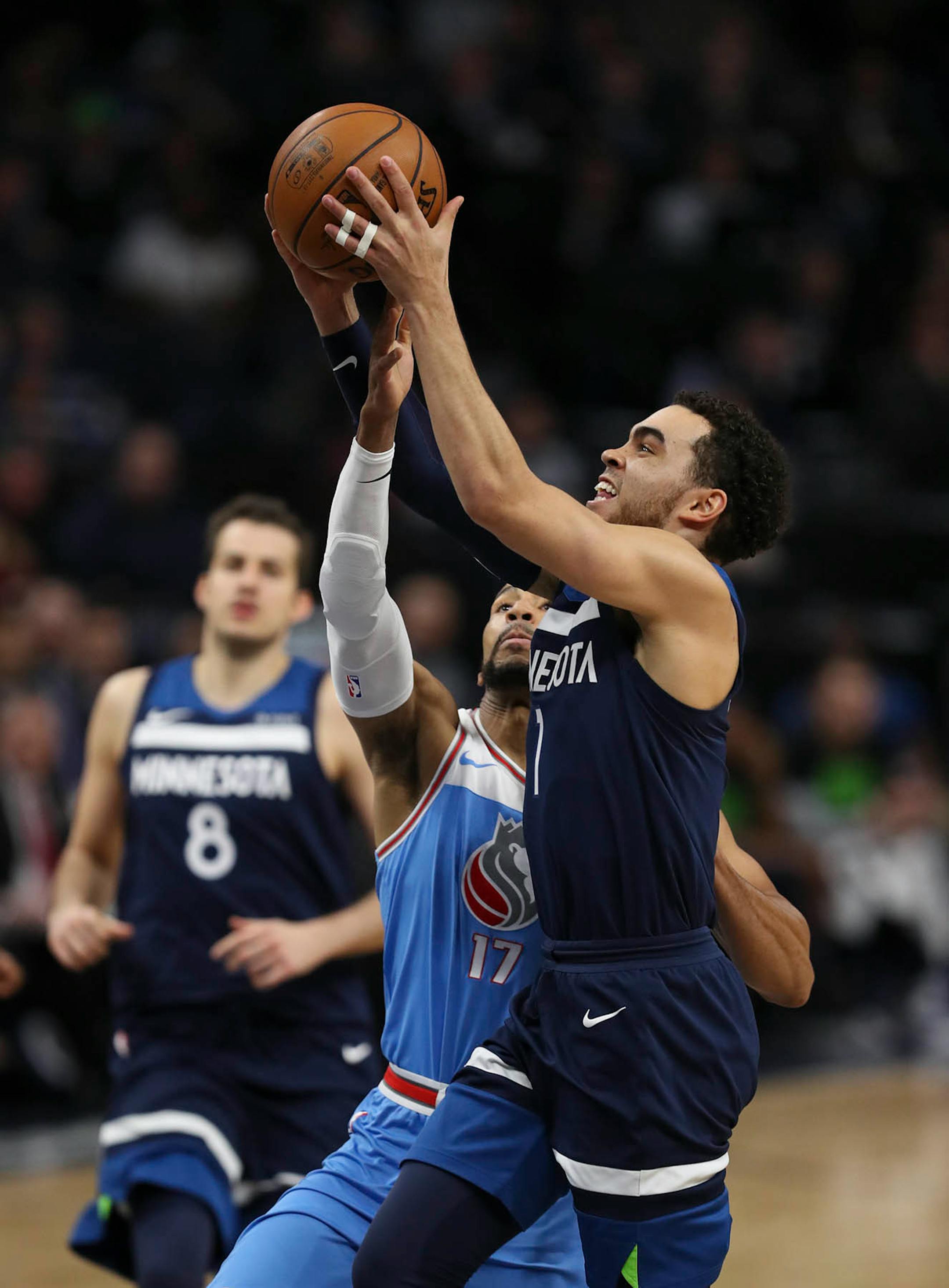 Sacramento Kings guard Garrett Temple (17) fouled Minnesota Timberwolves guard Tyus Jones (1) as he drove to the hoop in the fourth quarter.