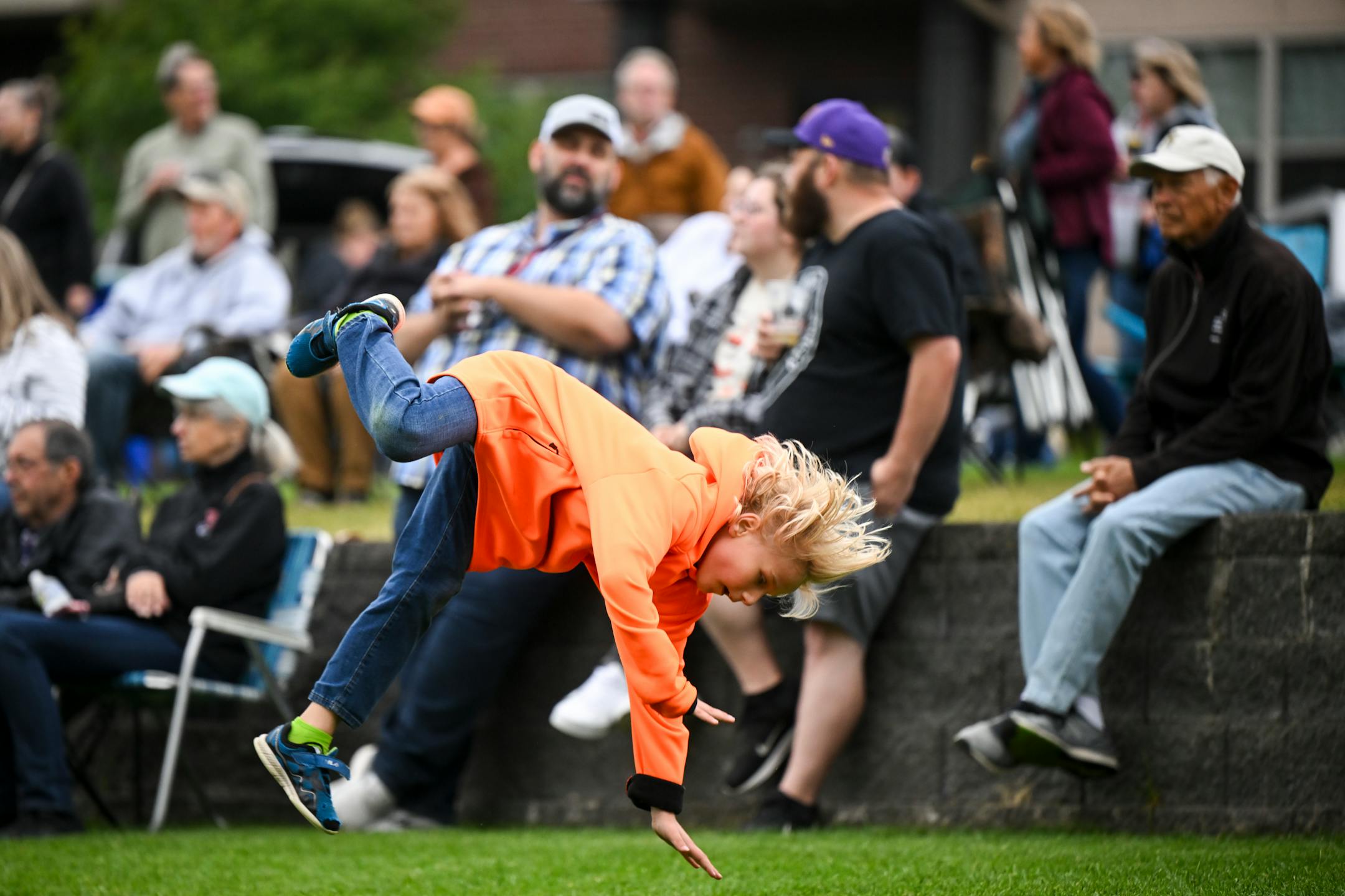 Jon Hartfiel, 7, of Anoka, practices his ninja skills in the grass Wednesday, Sept. 6, 2023 at Riverfront Memorial Park in Anoka, Minn. Starting Wednesday, anybody 21 and older may buy adult beverages from some bars and restaurants in Anoka and consume them as they walk on sidewalks, into shops that allow it, and along the riverfront in the city's historic downtown. The social district will pilot a project as a way to generate activity and bring people together. ] AARON LAVINSKY • aaron.lavinsky@startribune.com