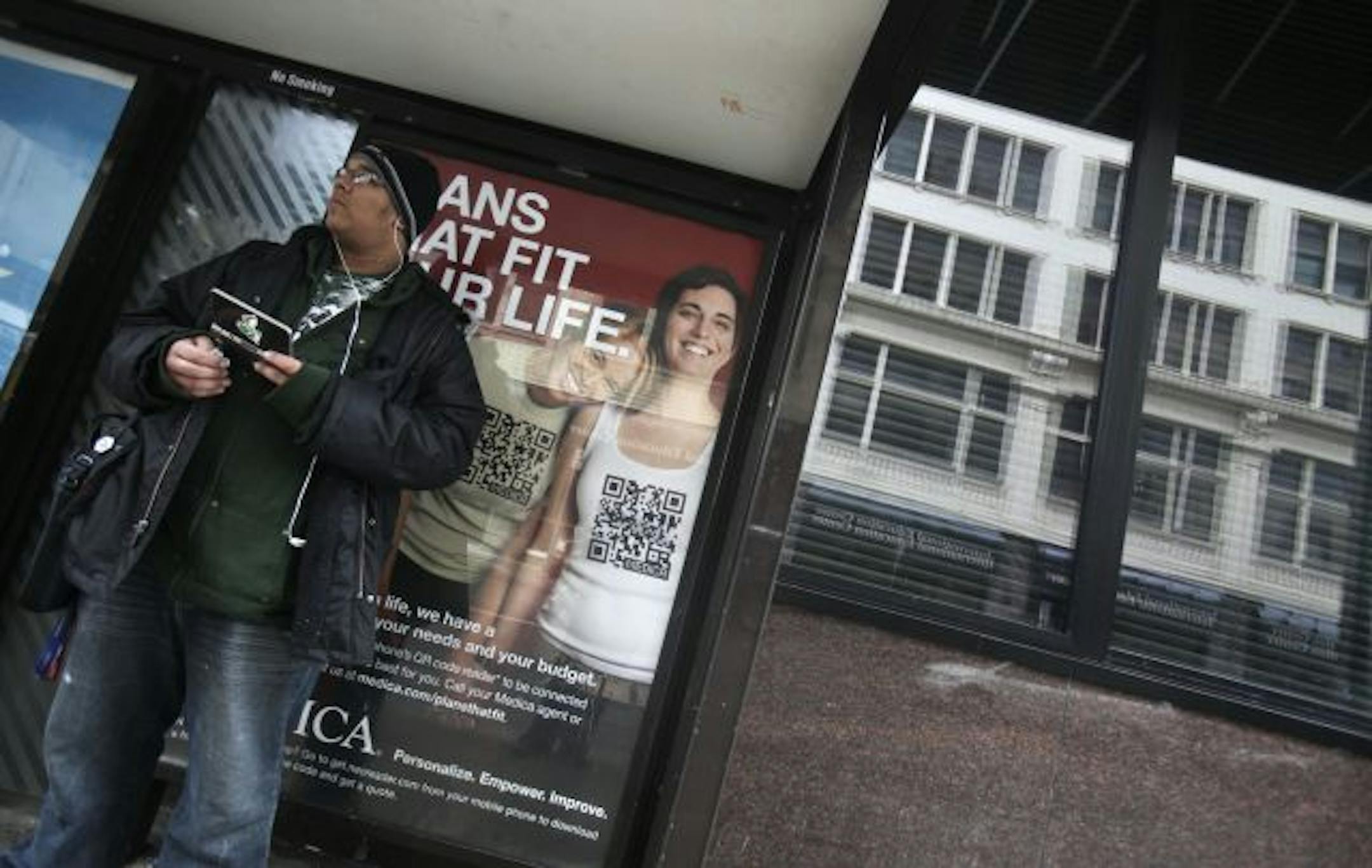 Evan Collins waited for a bus Wednesday on 8th Street near Hennepin Avenue S. in Minneapolis in front of one of Medica's new ads. The health insurer's campaign, unveiled Wednesday, targets single people, gays and lesbians, and young families.