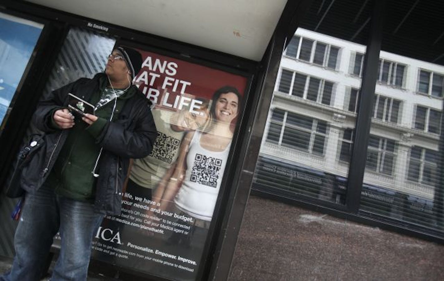 Evan Collins waited for a bus Wednesday on 8th Street near Hennepin Avenue S. in Minneapolis in front of one of Medica's new ads. The health insurer's campaign, unveiled Wednesday, targets single people, gays and lesbians, and young families.