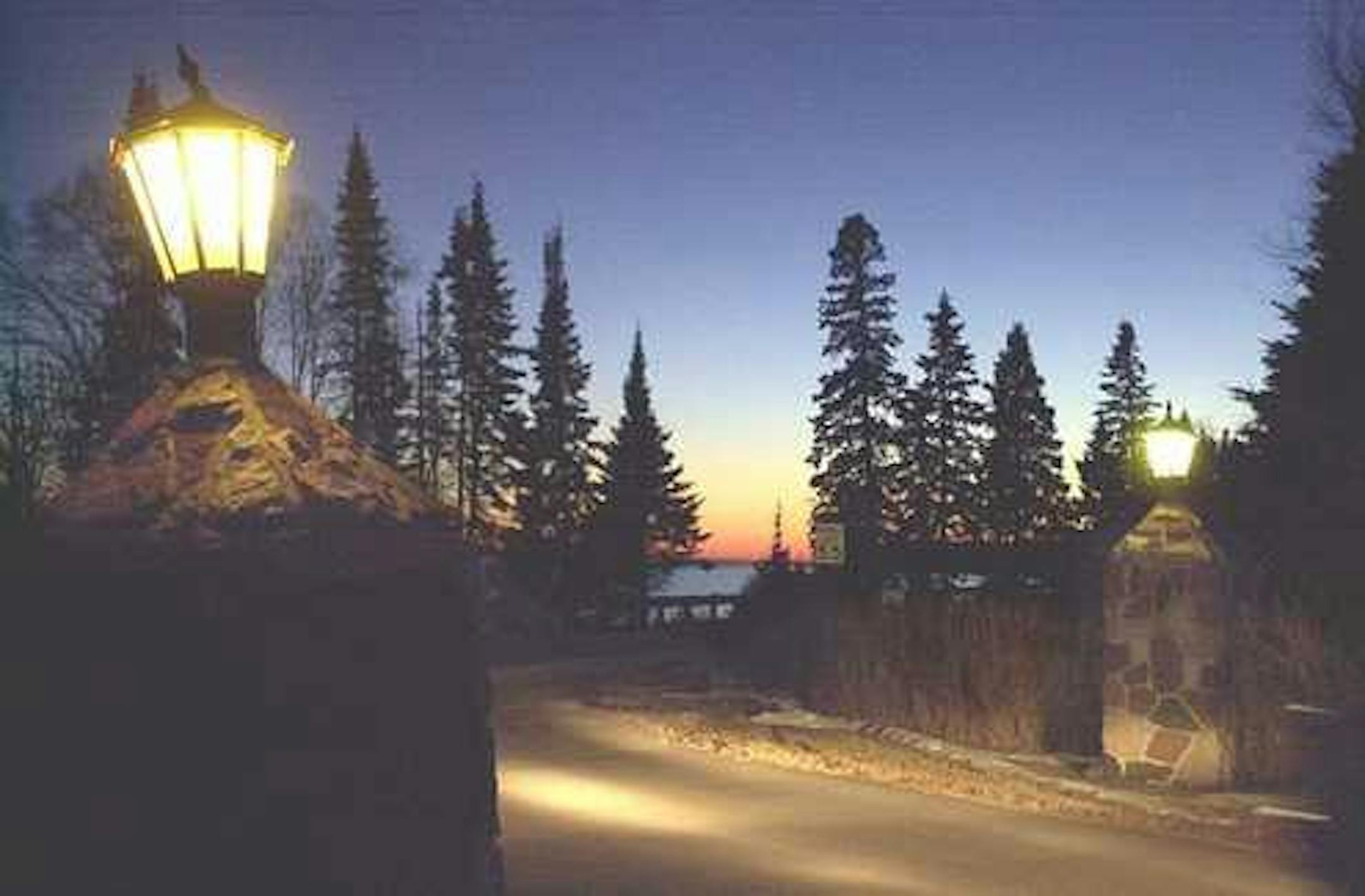 Lanterns atop stone pillars on Hwy. 61, across from Lake Superior, light the way to and from Cascade Lodge. The business includes a restaurant and cabins.