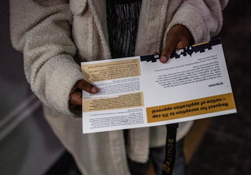 Sumeya Mohamed holds a postcard from the city&nbsp;saying her landlord was granted an exception to St. Paul's rent control law. The notice says her apartment's rent could increase by up to 26%.