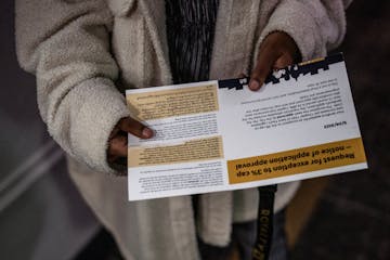 Sumeya Mohamed holds a postcard from the city&nbsp;saying her landlord was granted an exception to St. Paul's rent control law. The notice says her ap