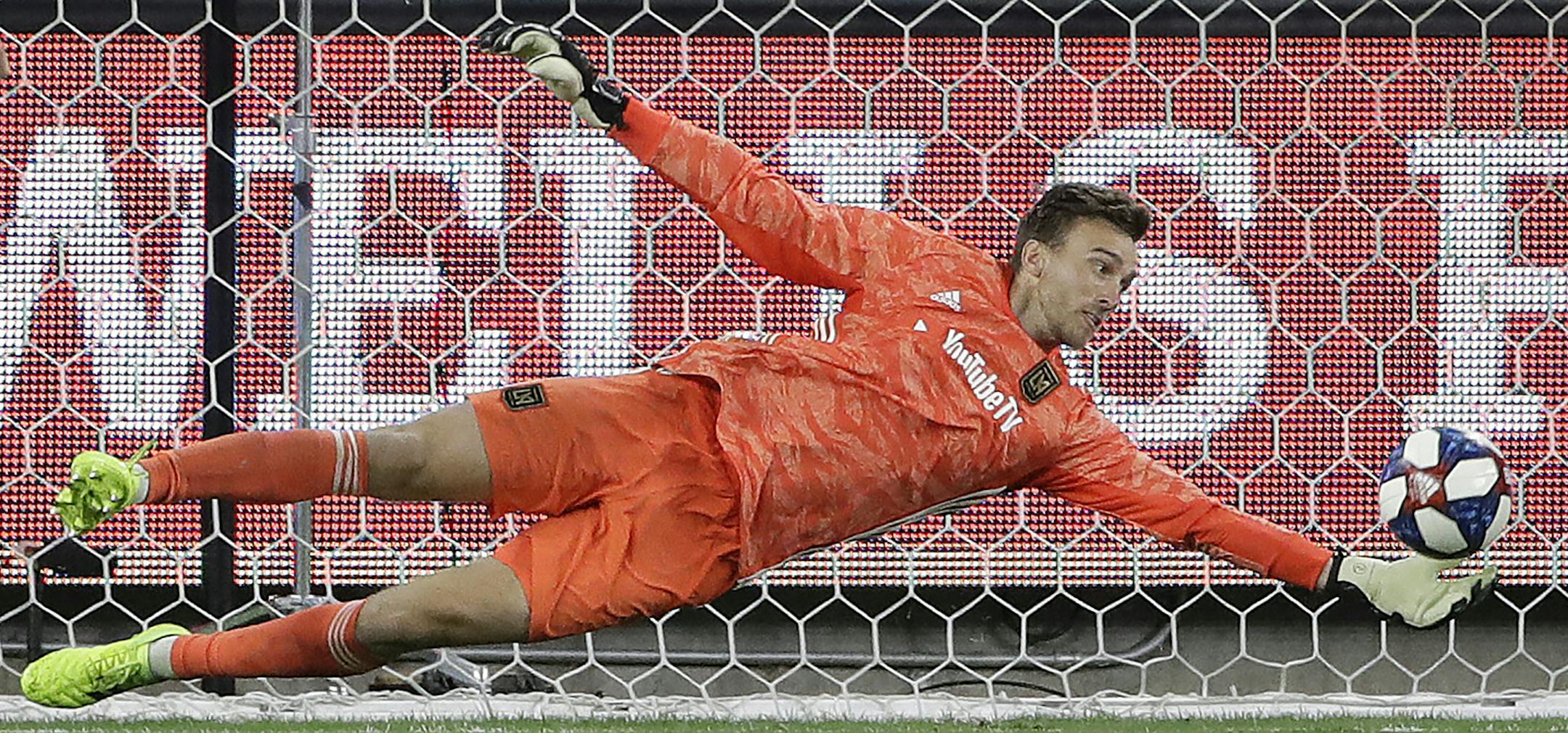 Los Angeles FC goalkeeper Tyler Miller stops a shot on goal by the San Jose Earthquakes during the second half of an MLS soccer match Wednesday, Aug. 21, 2019, in Los Angeles. (AP Photo/Marcio Jose Sanchez) ORG XMIT: CAMS113