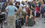 On Tuesday, stranded passengers waited at Hartsfield-Jackson International Airport in Atlanta, Ga., after Delta Air Lines canceled 300 flights as it a