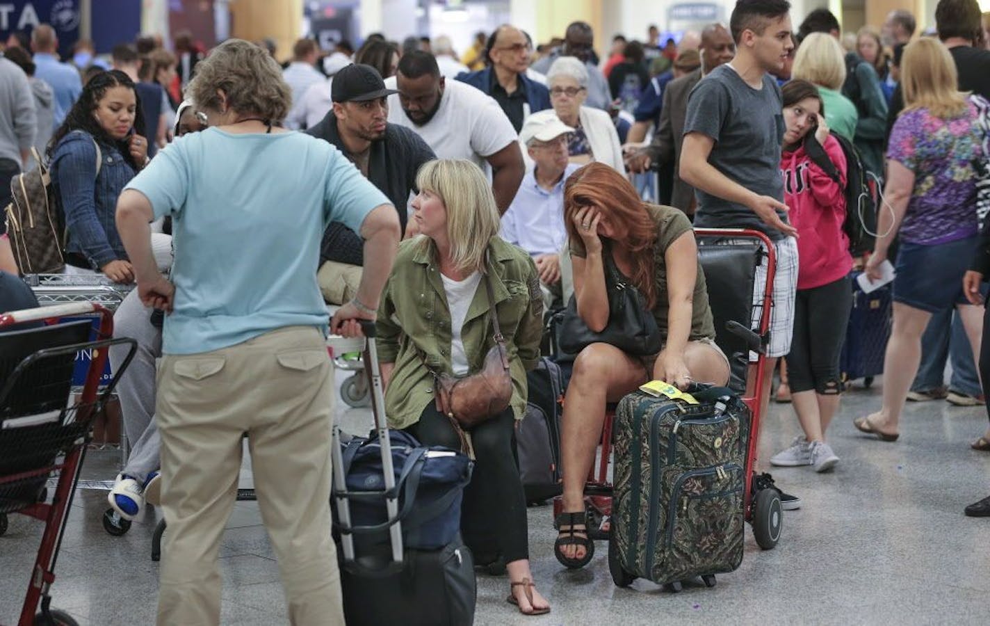 On Tuesday, stranded passengers waited at Hartsfield-Jackson International Airport in Atlanta, Ga., after Delta Air Lines canceled 300 flights as it attempted to recover from a computer outage that wreaked havoc on its operations Monday.