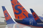 Sun Country airlines logo on 737 wing tips and tail at Humphrey terminal, MSP ] 2014 - for use with business related stories- illo ORG XMIT: MIN140703