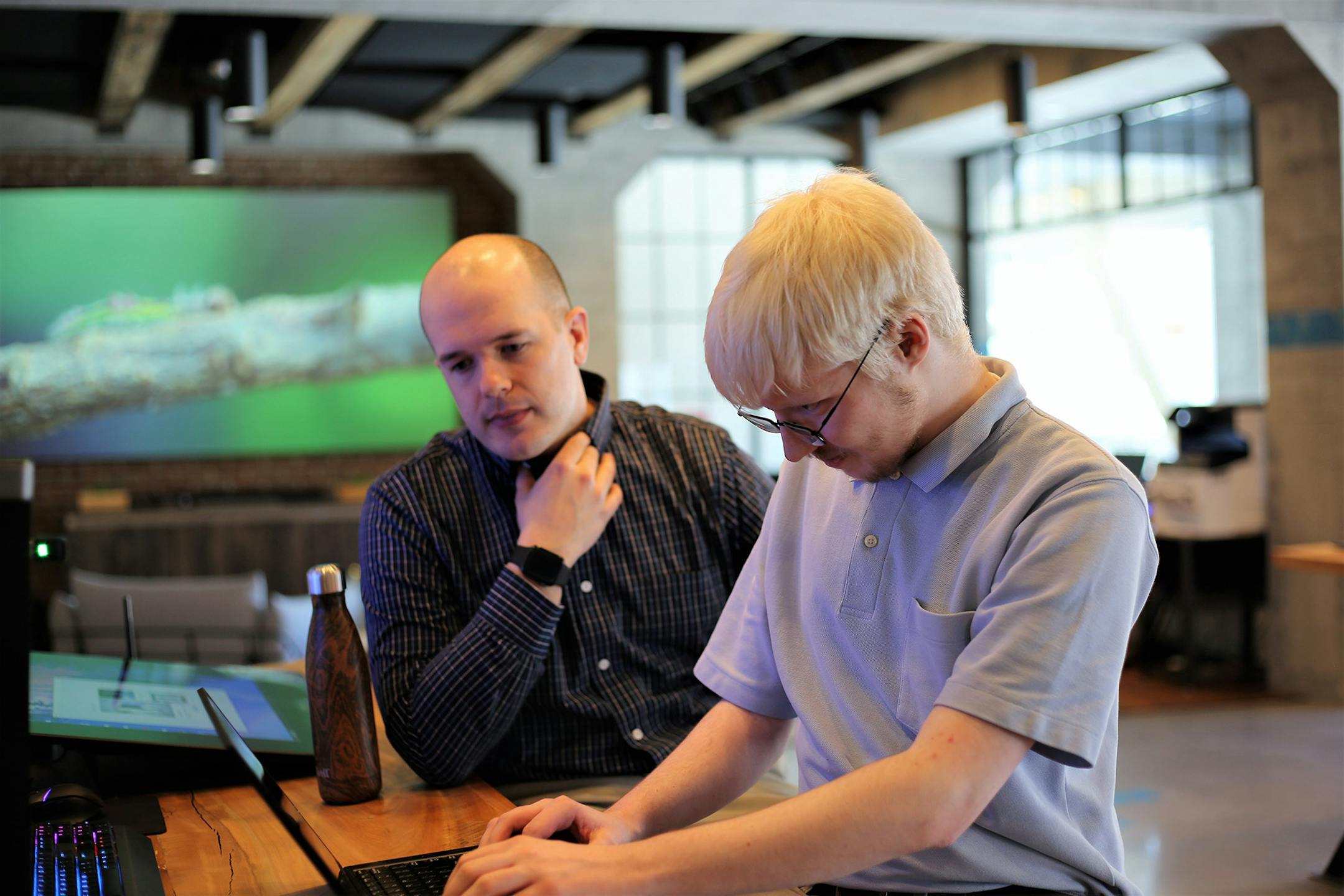 Dan Warfield, manager of data analytics and business intelligence at Dell Technologies, left, speaks to Charles “CJ” Surett, data intelligence engineer intern at Dell. After a successful pilot in Massachusetts, Dell Technologies is expanding its autism hiring program to Central Texas. (Dell Technologies/TNS) ORG XMIT: 1298651