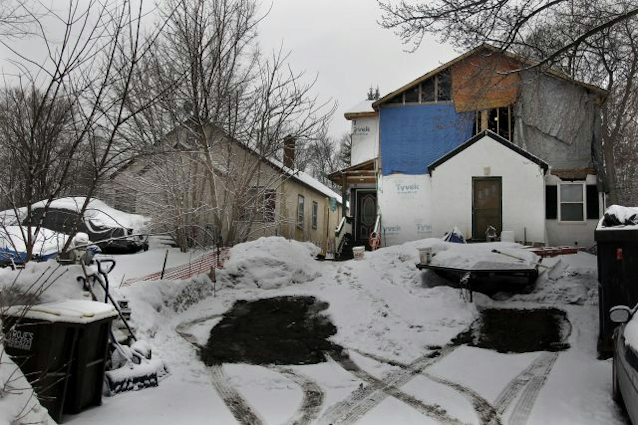 A front-side view of Keith Marsh's house, left, and his neighbor's incomplete project.