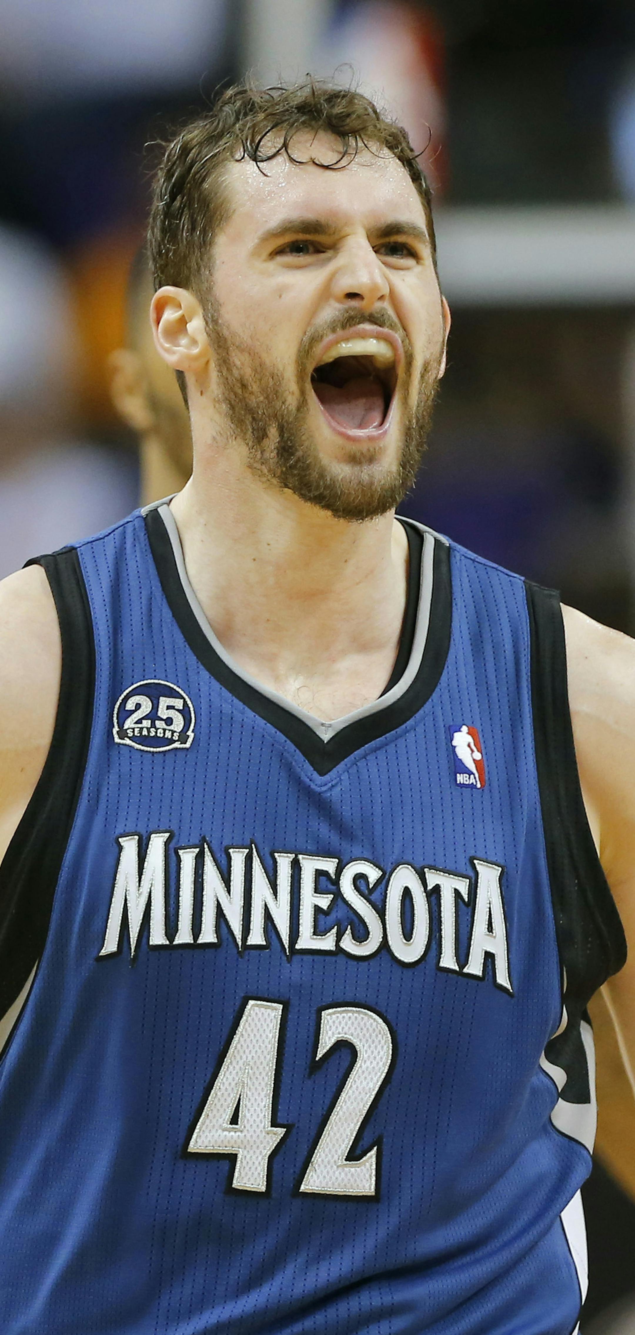 Minnesota Timberwolves forward Kevin Love (42) yells after hitting a three pointer against the Phoenix Suns during the second half of an NBA basketball game, Tuesday, Feb. 25, 2014, in Phoenix. (AP Photo/Matt York) ORG XMIT: PNU115
