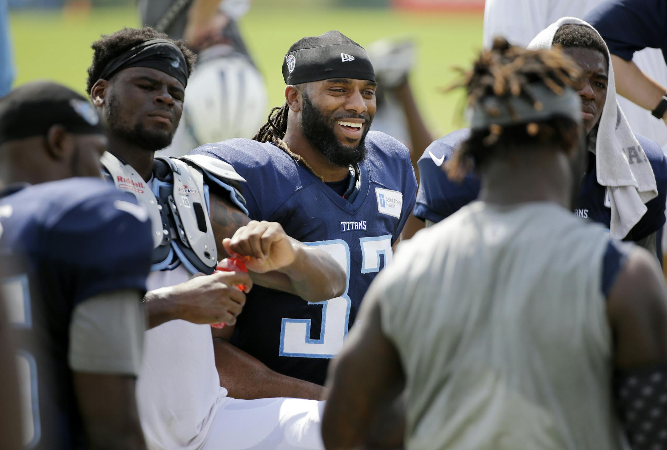 Tennessee Titans safety Michael Griffin, center, talks with teammates after a practice at NFL football training camp, Tuesday, Aug. 11, 2015, in Nashville, Tenn. Griffin, 30, known as ìOld Man Griff"or ìGrandpa" by his teammates, is heading into his ninth NFL season. He is not only Tennesseeís oldest player on defense but also the longest-tenured player on this roster. (AP Photo/Mark Humphrey) ORG XMIT: TNMH101
