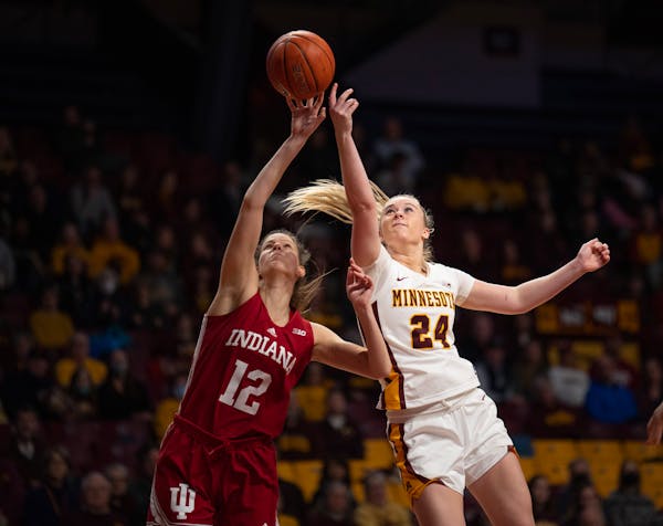 Minnesota Gophers forward Mallory Heyer (24) and Indiana Hoosiers guard Yarden Garzon (12) both went for a Gophers rebound in the third quarter.