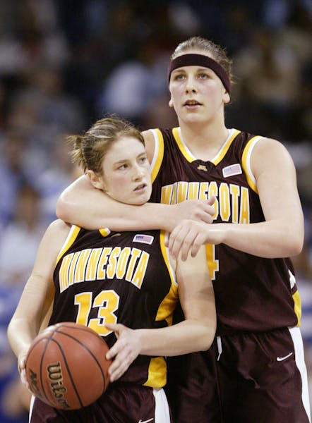 Minnesota's Janel McCarville, right, hugs teammate Lindsay Whalen near the end of the NCAA Mideast final game against Duke Tuesday, March 30, 2004, in