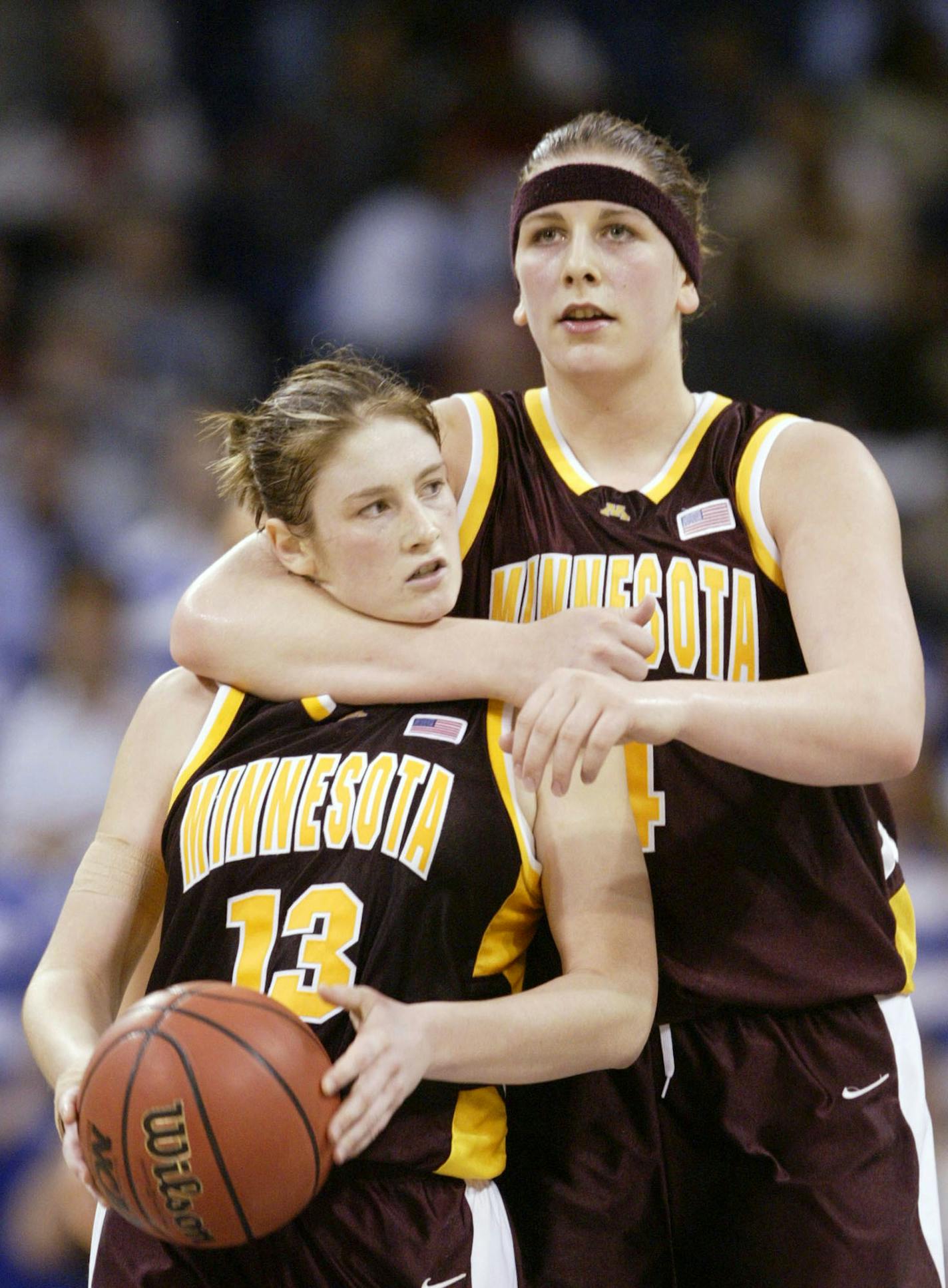 Minnesota's Janel McCarville, right, hugs teammate Lindsay Whalen near the end of the NCAA Mideast final game against Duke Tuesday, March 30, 2004, in Norfolk, Va. (AP Photo/Chuck Burton) ORG XMIT: VARL120 ORG XMIT: MIN1305162100231251