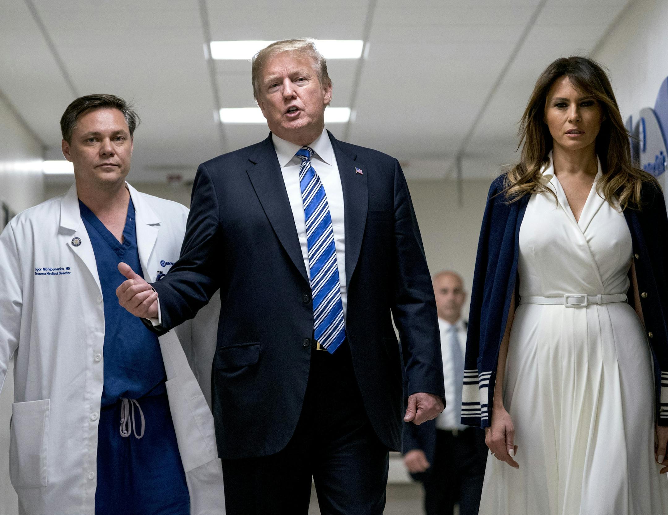 President Donald Trump, center, with first lady Melania Trump, right, and Dr. Igor Nichiporenko, left, spoke Friday while visiting Broward Health North in Pompano Beach, Fla., after the school shooting two days ago.