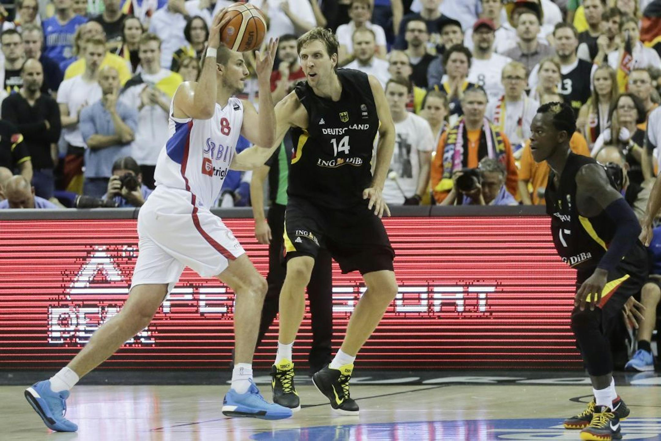 Serbia�s Nemanja Bjelica, left, goes for a shot over Germany�s Dirk Nowitzki, center, and Germany�s Dennis Schroeder, right, during the EuroBasket European Basketball Championship group B match between Serbia and Germany in Berlin, Germany, Sunday, Sept. 6, 2015.