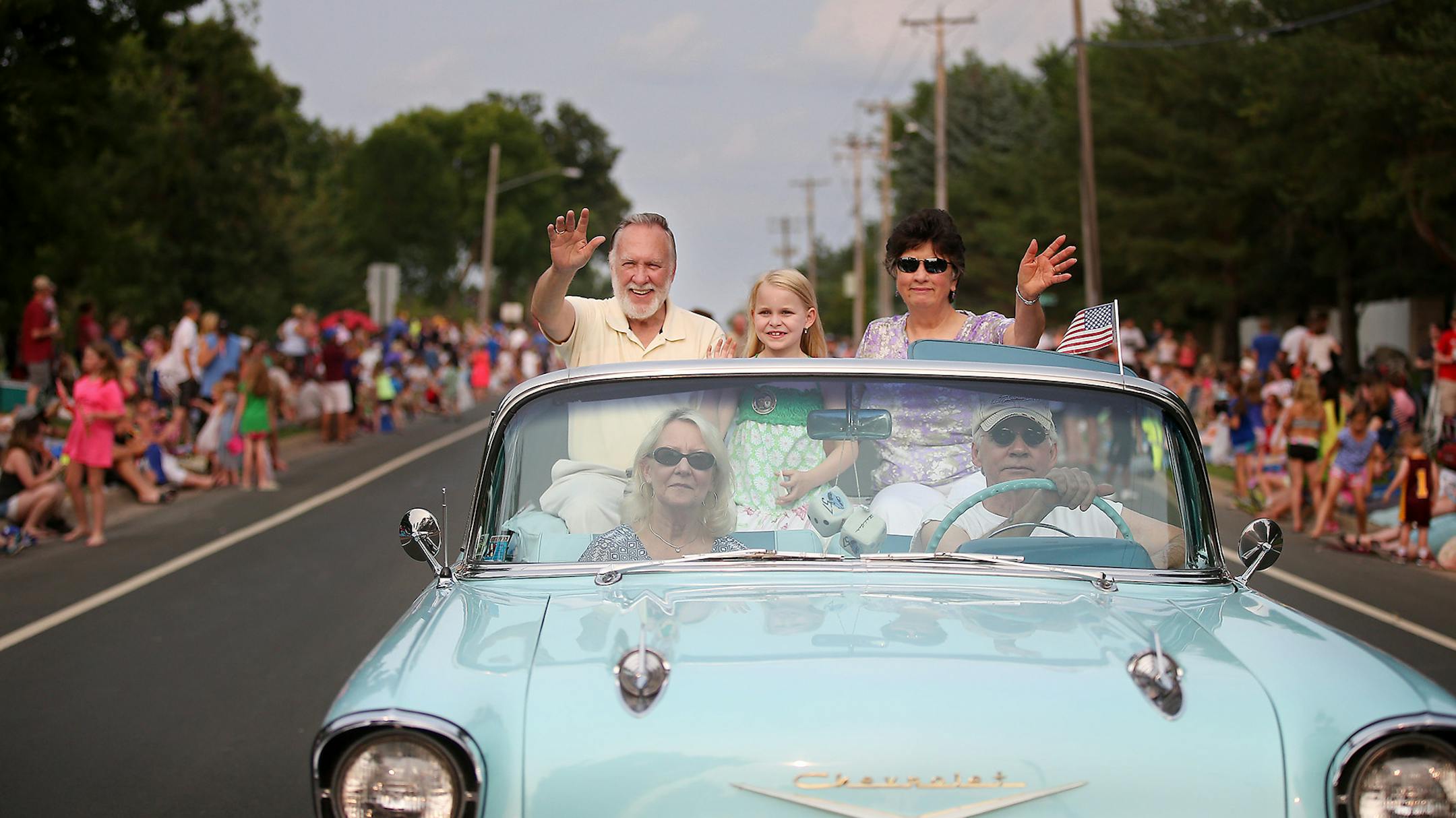 Maple Grove City Administrator Al Madsen waved to the crowds as the Maple Grove Days grand marshal. He was riding with his granddaughter Ellie Bennington, 7, and his wife, Sharon Madsen.