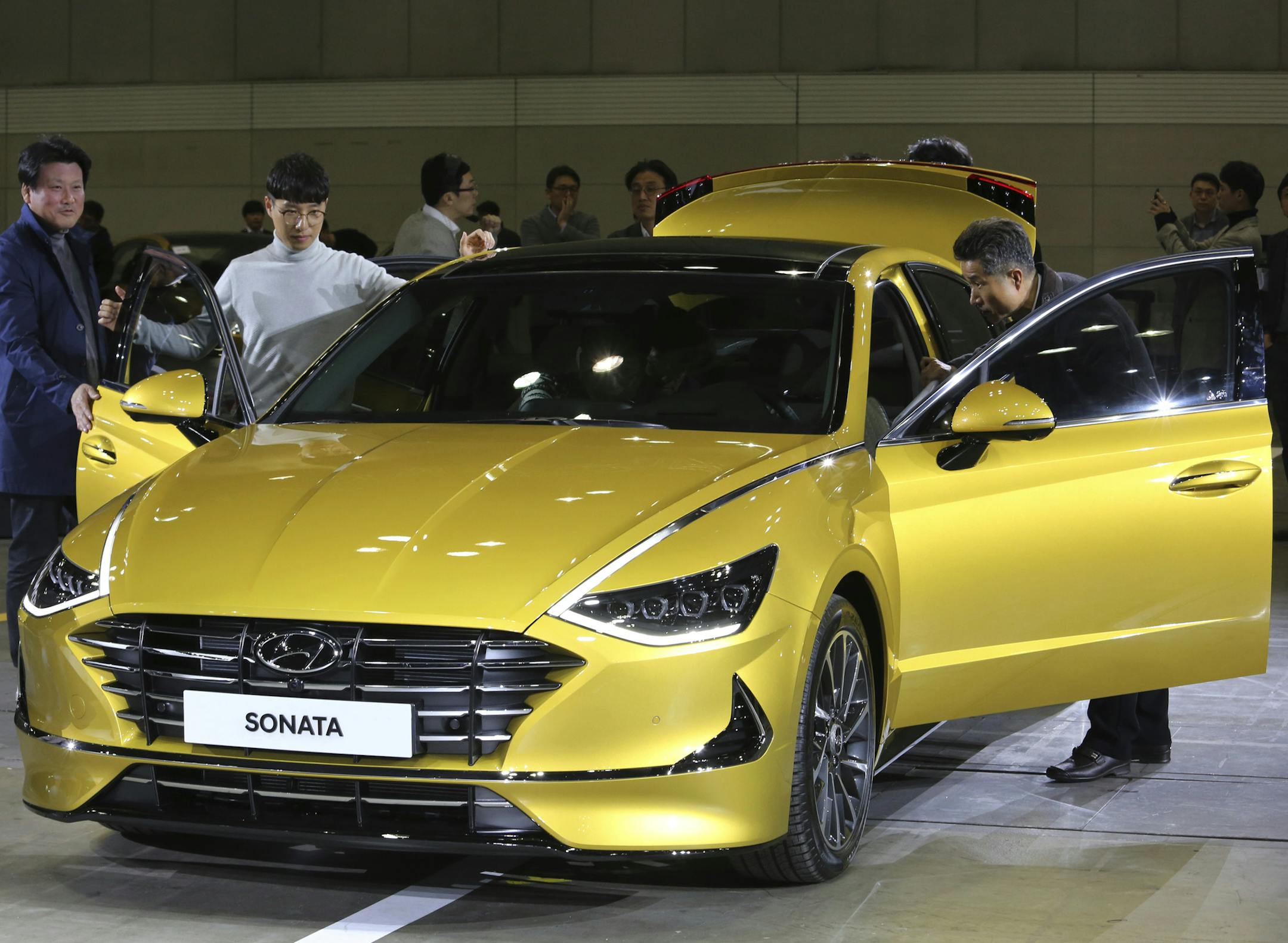 Participants watch a Hyundai Motors' all-new Sonata sedan during its unveiling ceremony in Goyang, South Korea, Thursday, March 21, 2019. The sedan, equipped with 2,000cc gasoline engine, is priced from 23.5 million won (US$21,150) to 32.9 million won (US$29,610). (AP Photo/Ahn Young-joon) ORG XMIT: SEL103