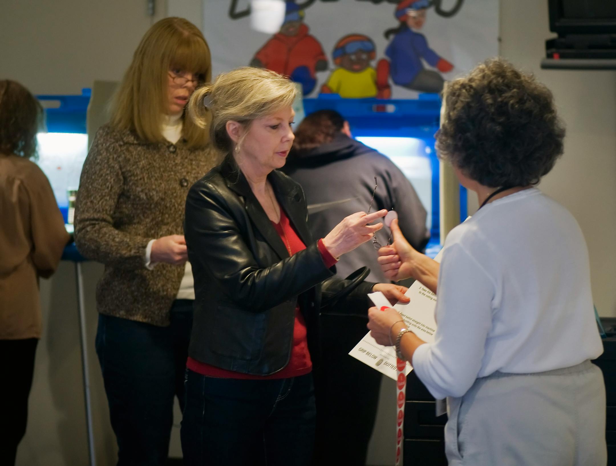 Jane Shaw gets her "I Voted" sticker after voting early Tuesday morning at the Burnsville Precinct 16 poll at the Buck Hill Ski Resort Lodge.
