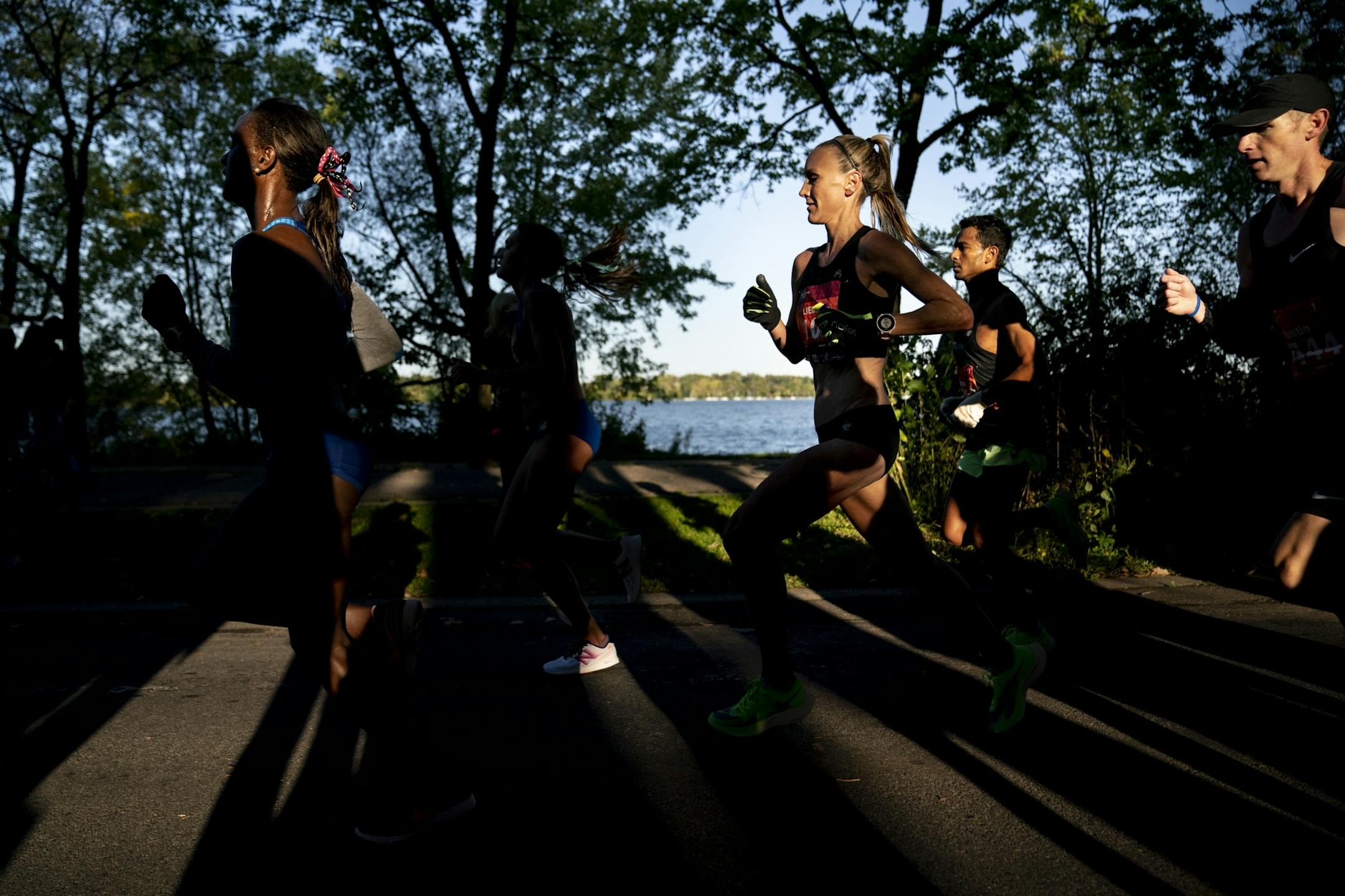 The men's and women's leaders ran past Lake Harriet in the morning light at almost mile 8 during the 2019 Medtronic Twin Cities Marathon.