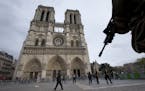 A soldier patrols at Notre Dame cathedral in Paris, Monday, Nov. 16, 2015. France is urging its European partners to move swiftly to boost intelligenc