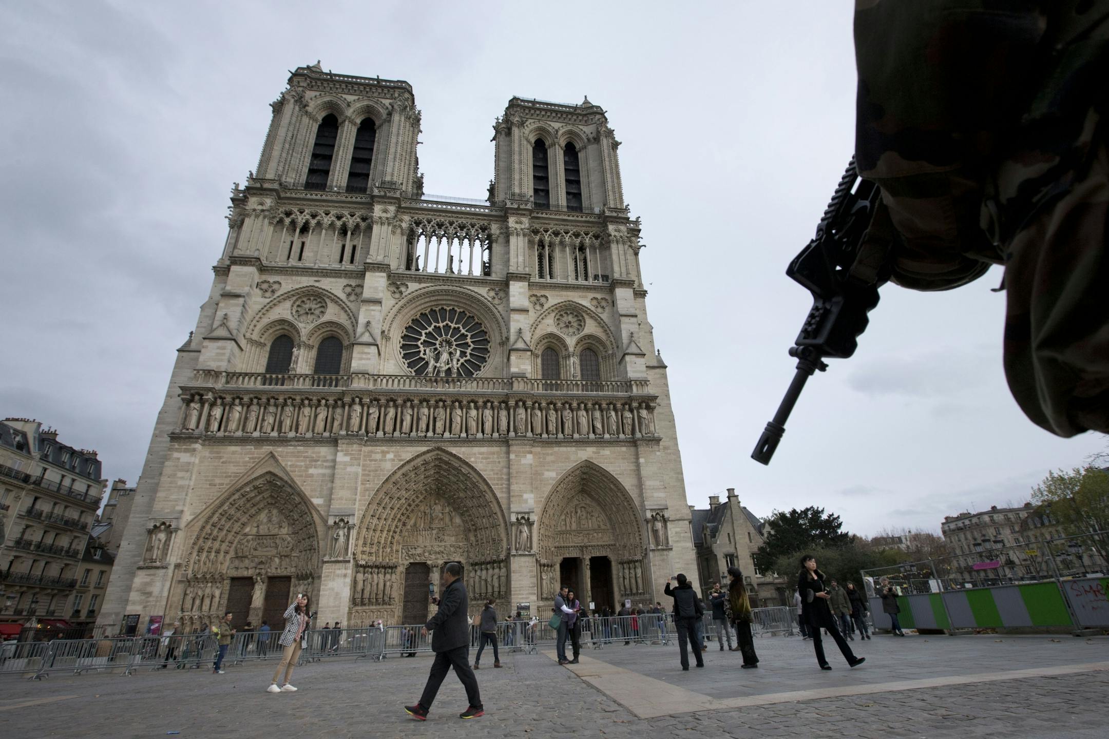 A soldier patrols at Notre Dame cathedral in Paris, Monday, Nov. 16, 2015. France is urging its European partners to move swiftly to boost intelligence sharing, fight arms trafficking and terror financing, and strengthen border security in the wake of the Paris attacks.